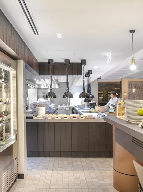 Buffet breakfast area at Holiday Inn & Suites Geelong with fresh fruits and juices.