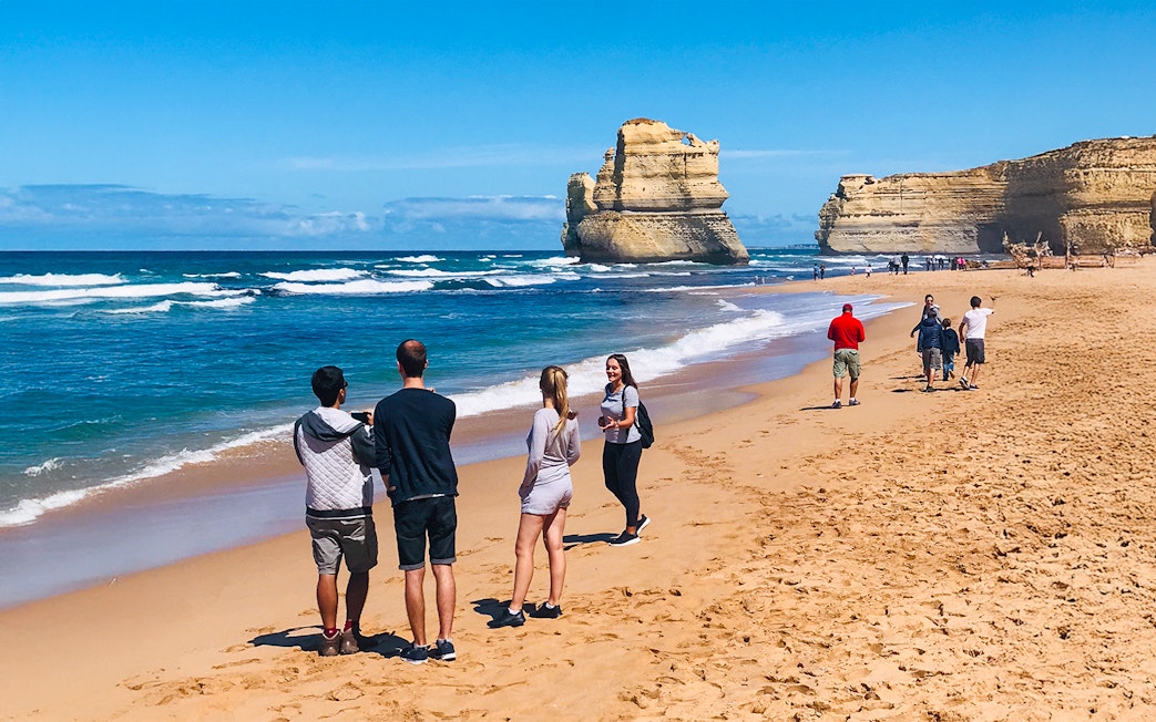 People walking on a beach near the 12 Apostles, Great Ocean Road.