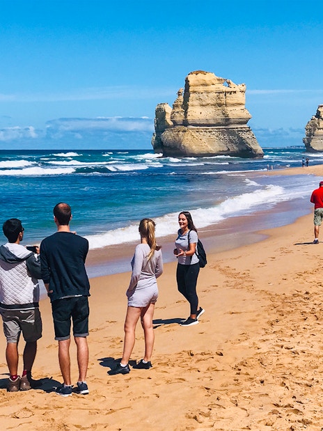 People walking on a beach near the 12 Apostles, Great Ocean Road.
