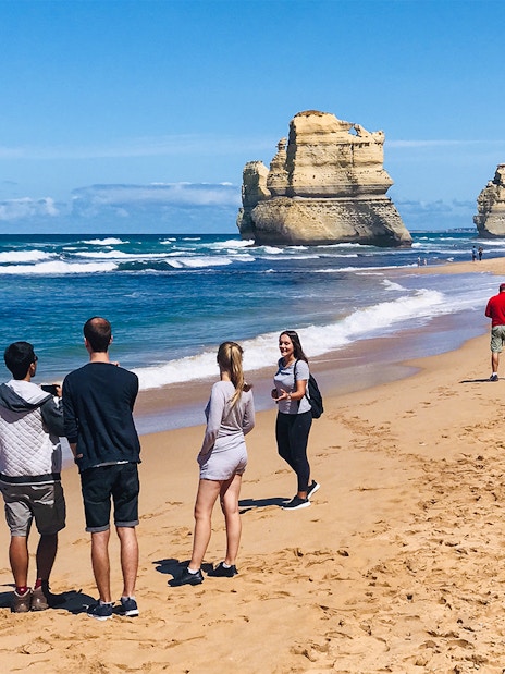 People walking on a beach near the 12 Apostles, Great Ocean Road.