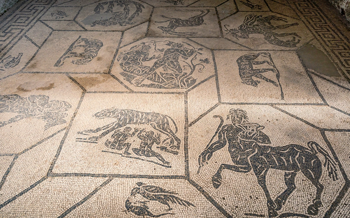 Ancient mosaic floor with mythological figures at Ostia Antica, Italy.