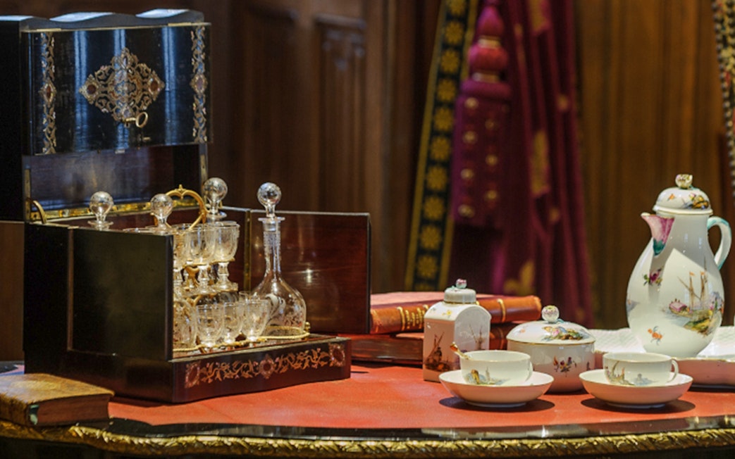 Antique tea set and crystal decanter on display at Azay-le-Rideau interiors.