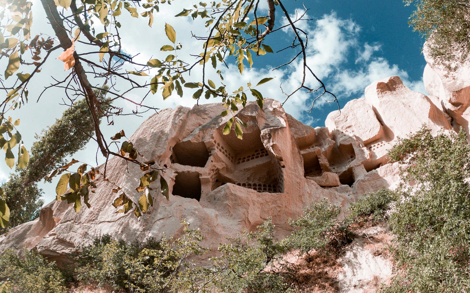Group of tourists exploring the unique rock formations of Cappadocia during the Red Tour, with a visit to the Fairychimney and Zelve Open-Air Museum
