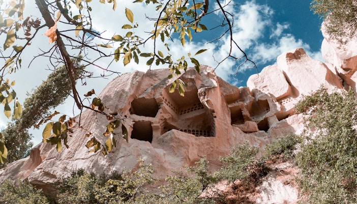 Group of tourists exploring the unique rock formations of Cappadocia during the Red Tour, with a visit to the Fairychimney and Zelve Open-Air Museum