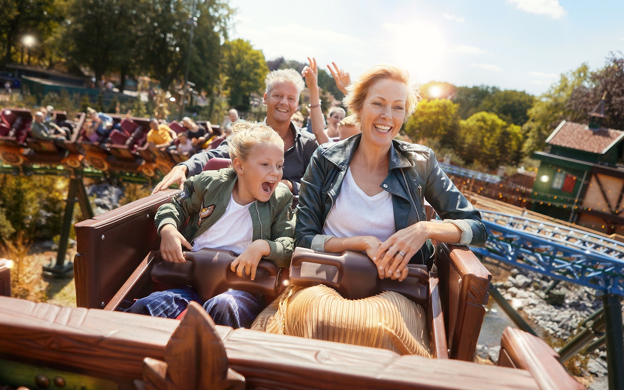 Family enjoying a roller coaster ride at Efteling theme park, Netherlands.