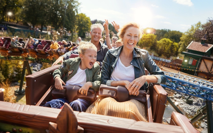 Family enjoying a roller coaster ride at Efteling theme park, Netherlands.