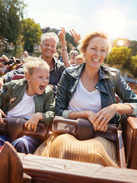 Family enjoying a roller coaster ride at Efteling theme park, Netherlands.