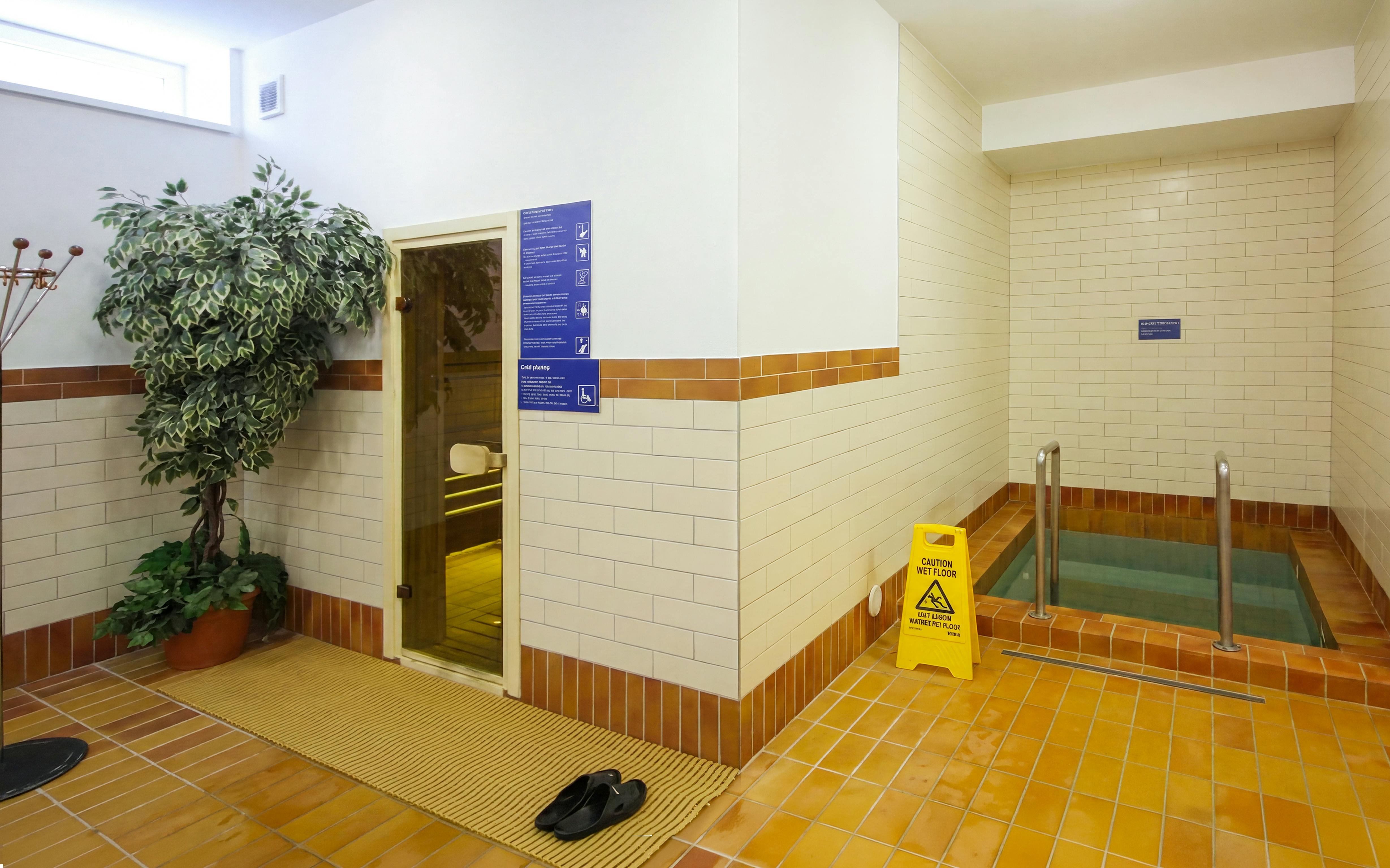 Spa entrance with sauna door and cold plunge pool at Dandar Spa.