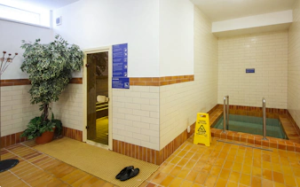 Spa entrance with sauna door and cold plunge pool at Dandar Spa.