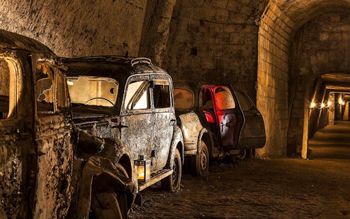 Abandoned vintage cars in the underground Bourbon Tunnel, Naples.