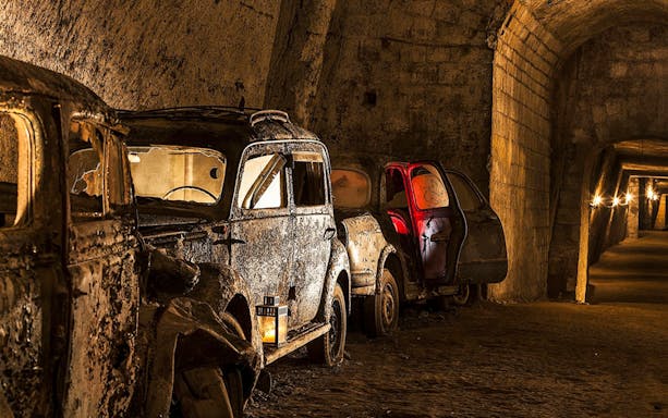 Abandoned vintage cars in the underground Bourbon Tunnel, Naples.