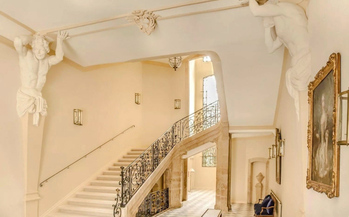 Staircase with ornate railing and sculptures at Caumont Centre d’Art, Aix-en-Provence.
