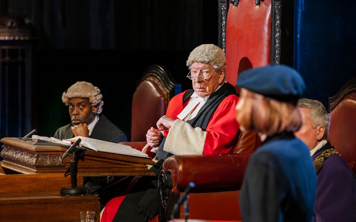 Cast of "Witness for the Prosecution" in courtroom attire during West End show.