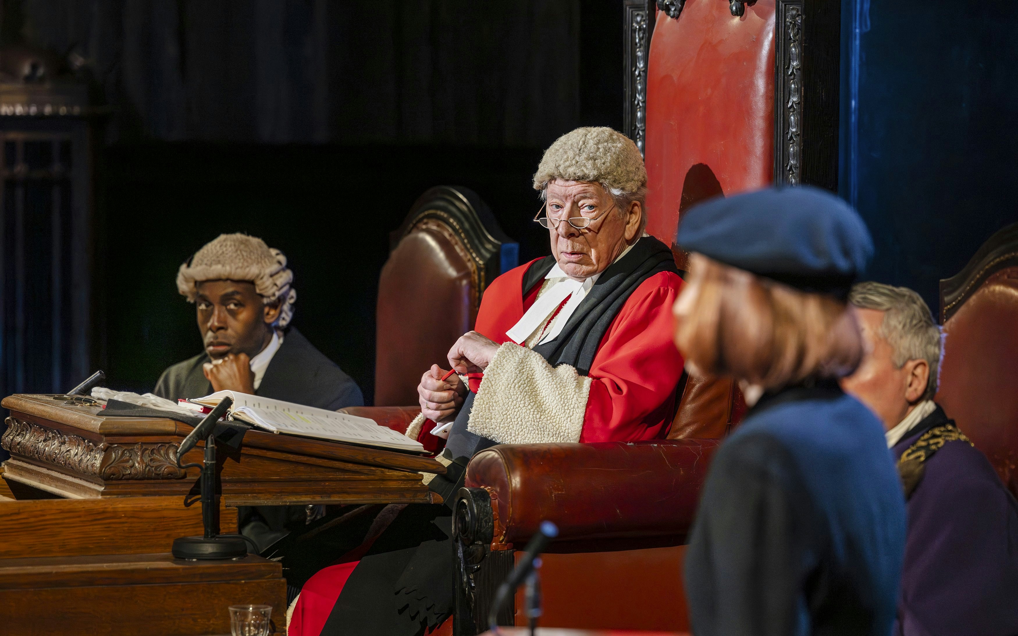 Cast of "Witness for the Prosecution" in courtroom attire during West End show.