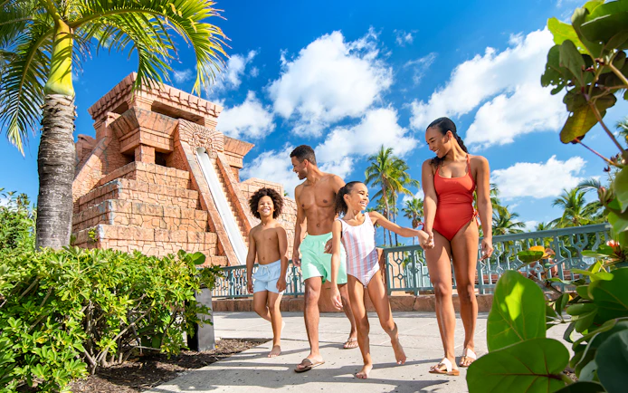Family walking near water slide at Atlantis Aquaventure, Nassau, Bahamas.