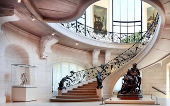 Elegant staircase and sculpture inside Petit Palais, Paris, with Bruno Liljefors exhibition.