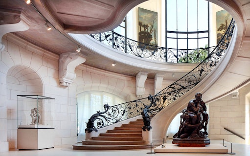Elegant staircase and sculpture inside Petit Palais, Paris, with Bruno Liljefors exhibition.
