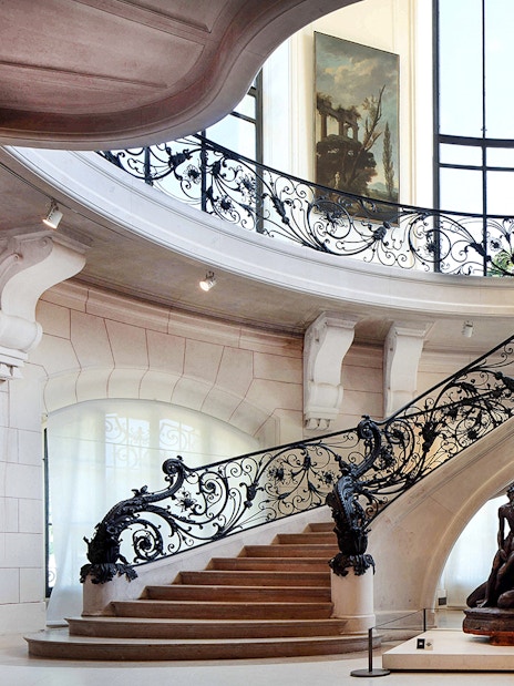 Elegant staircase and sculpture inside Petit Palais, Paris, with Bruno Liljefors exhibition.