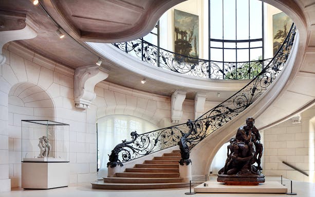 Elegant staircase and sculpture inside Petit Palais, Paris, with Bruno Liljefors exhibition.
