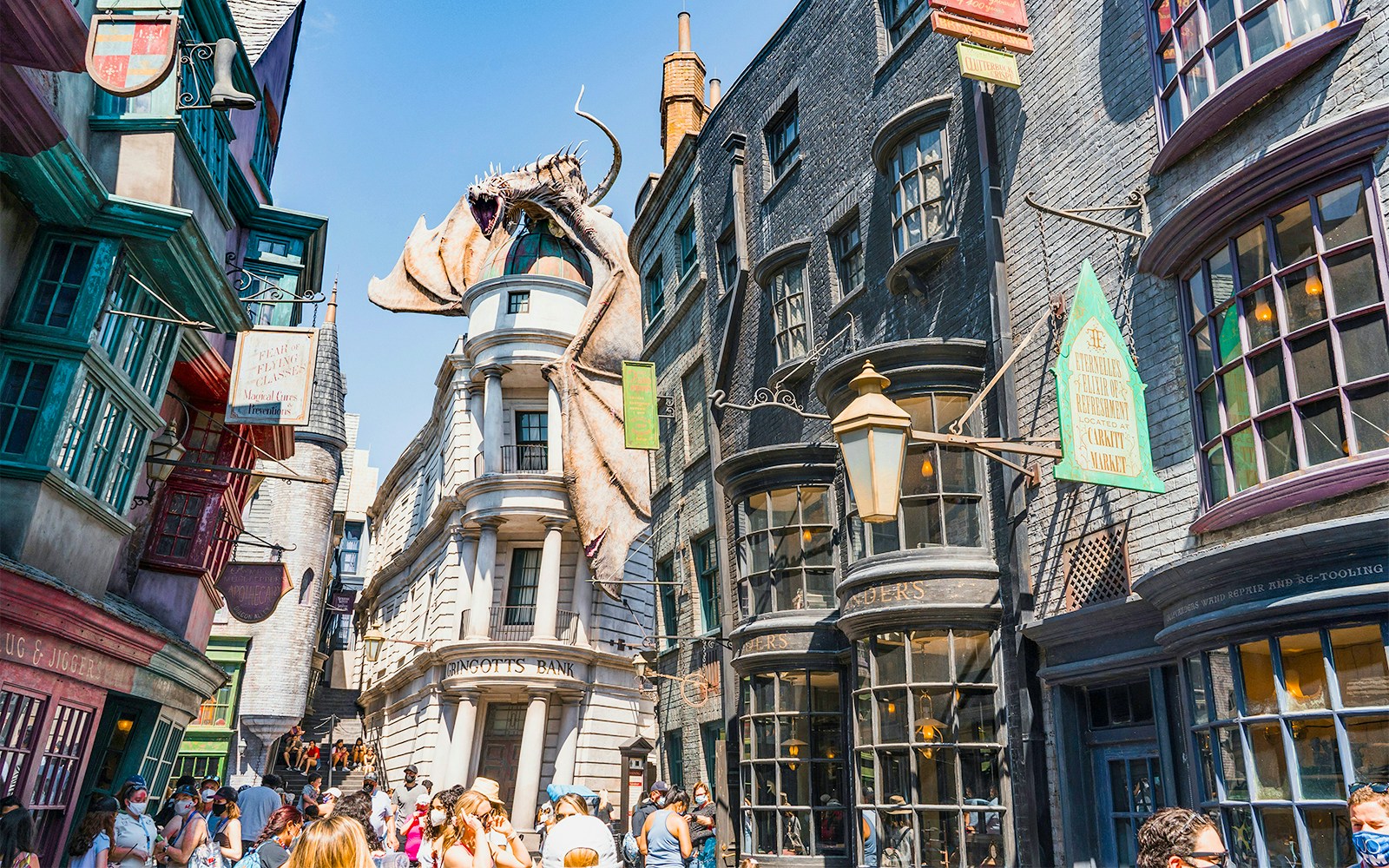 Diagon Alley shops with Gringotts Bank and dragon at Universal Orlando's Wizarding World of Harry Potter.
