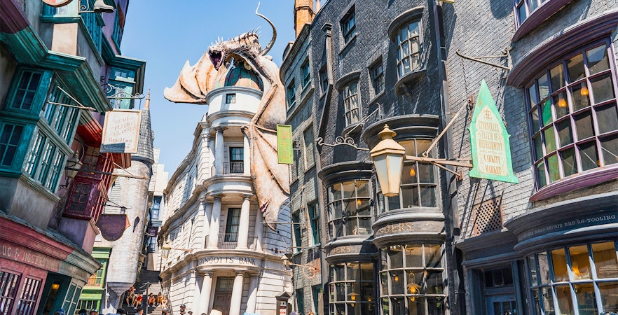 Diagon Alley shops with Gringotts Bank and dragon at Universal Orlando's Wizarding World of Harry Potter.