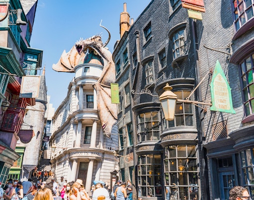 Diagon Alley shops with Gringotts Bank and dragon at Universal Orlando's Wizarding World of Harry Potter.