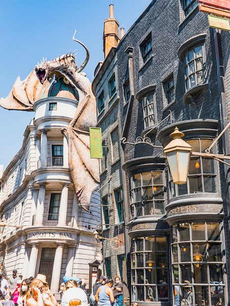 Diagon Alley shops with Gringotts Bank and dragon at Universal Orlando's Wizarding World of Harry Potter.
