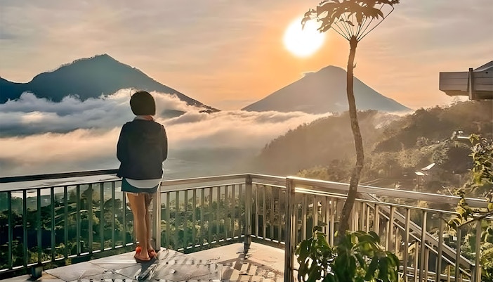 Woman watching mount batur from a cafe in Kintamani