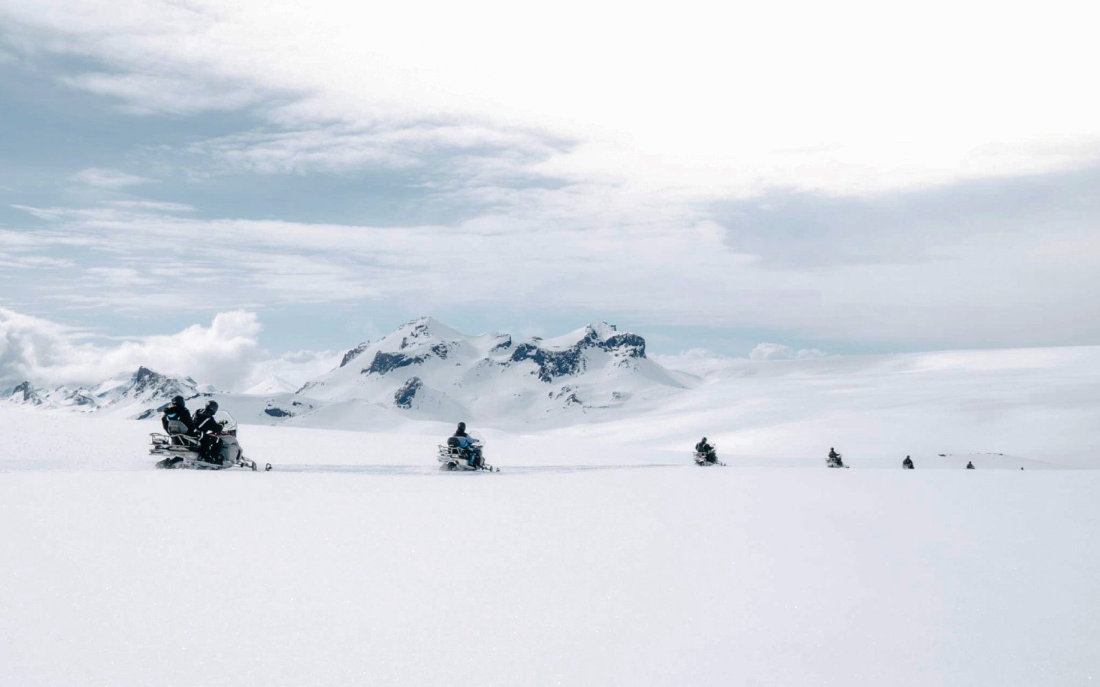 Snowmobile tour from Gullfoss waterfall across snowy Icelandic landscape.