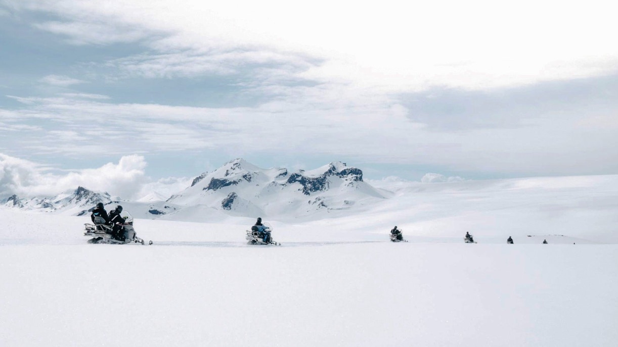 Snowmobile tour from Gullfoss waterfall across snowy Icelandic landscape.