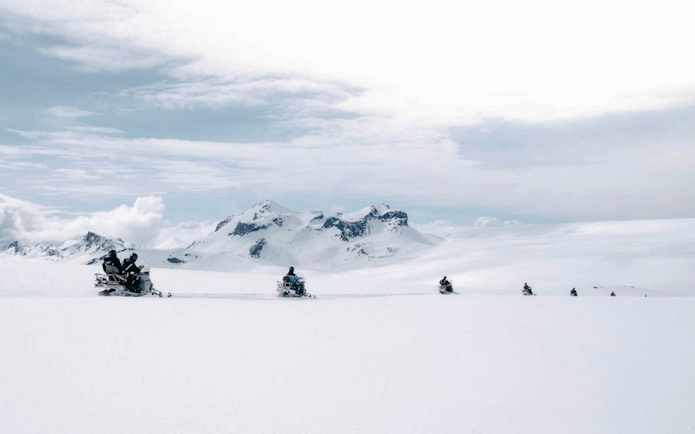 Snowmobile tour from Gullfoss waterfall across snowy Icelandic landscape.