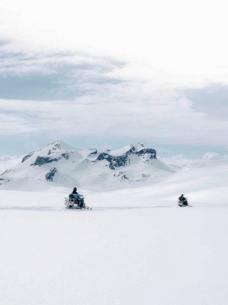 Snowmobile tour from Gullfoss waterfall across snowy Icelandic landscape.