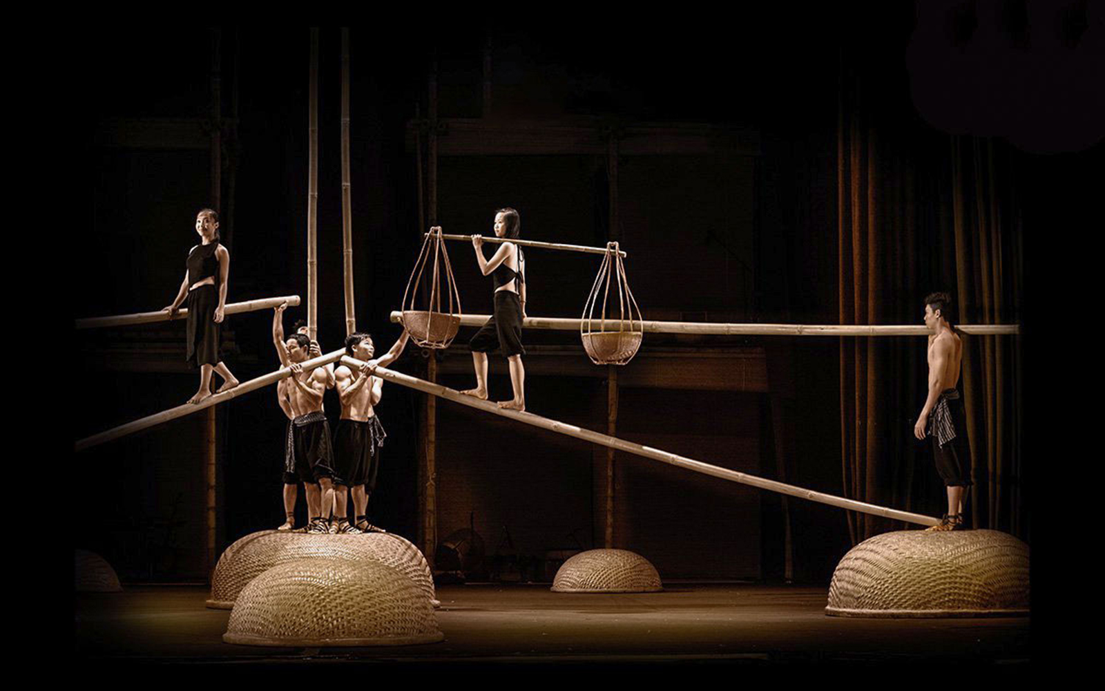 Performers balancing on bamboo poles at A O Show circus.