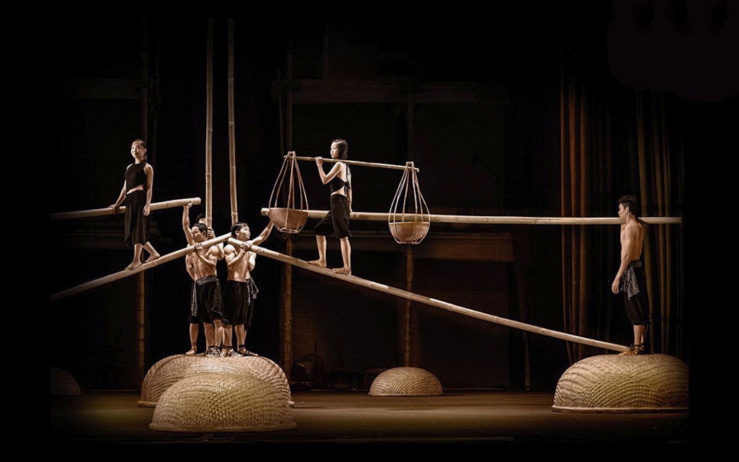 Performers balancing on bamboo poles at A O Show circus.