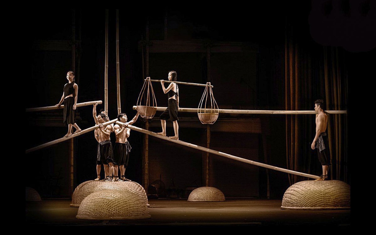 Performers balancing on bamboo poles at A O Show circus.