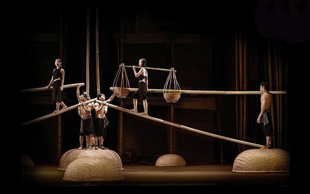 Performers balancing on bamboo poles at A O Show circus.