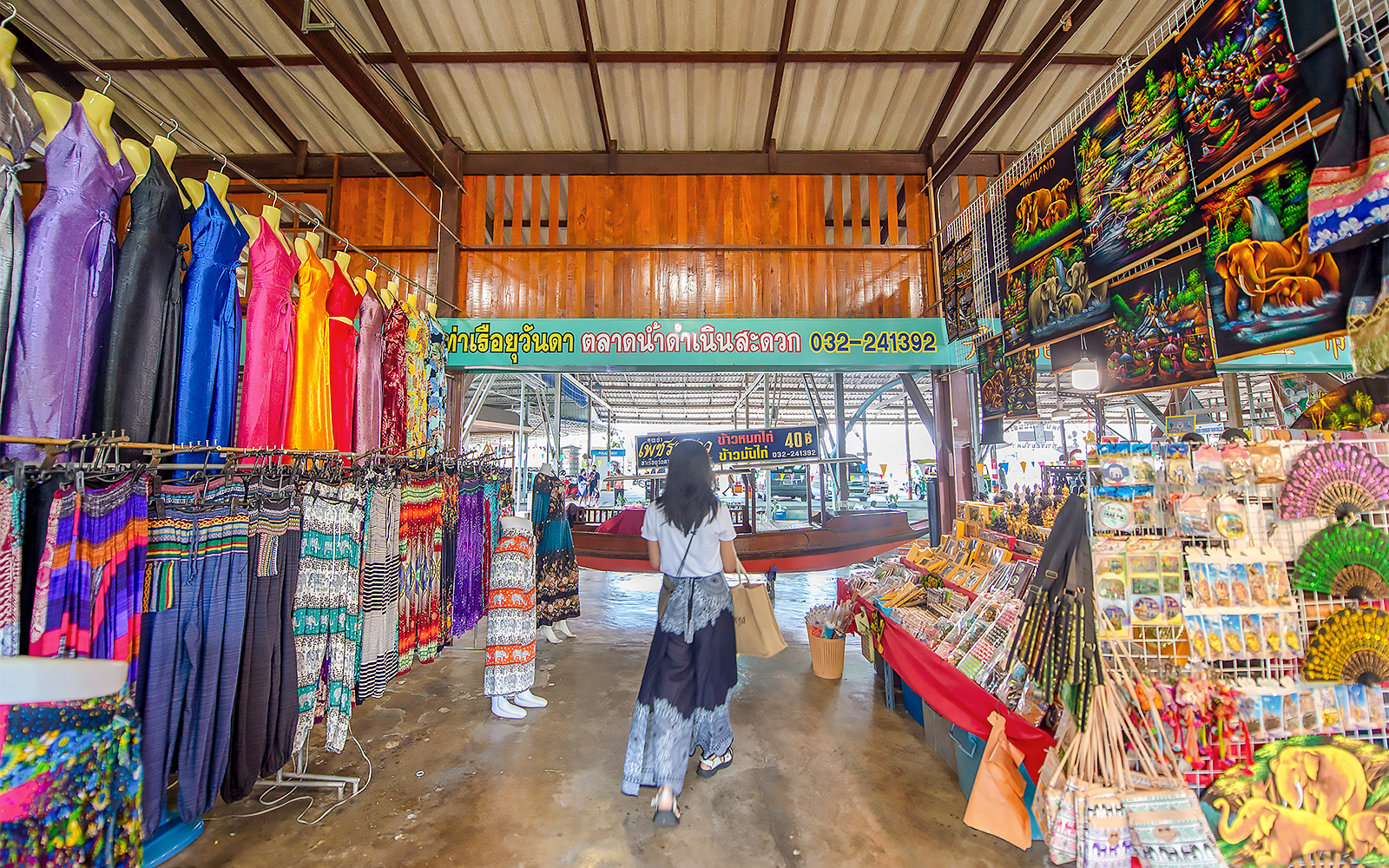 Colorful clothing and souvenirs at Damnoen Saduak Floating Market, Thailand.