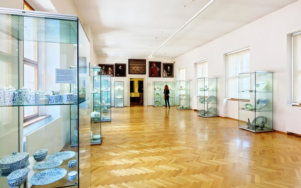 Lobkowicz Palace Museum interior with glass display cases and art exhibits.