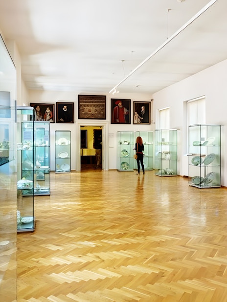Lobkowicz Palace Museum interior with glass display cases and art exhibits.