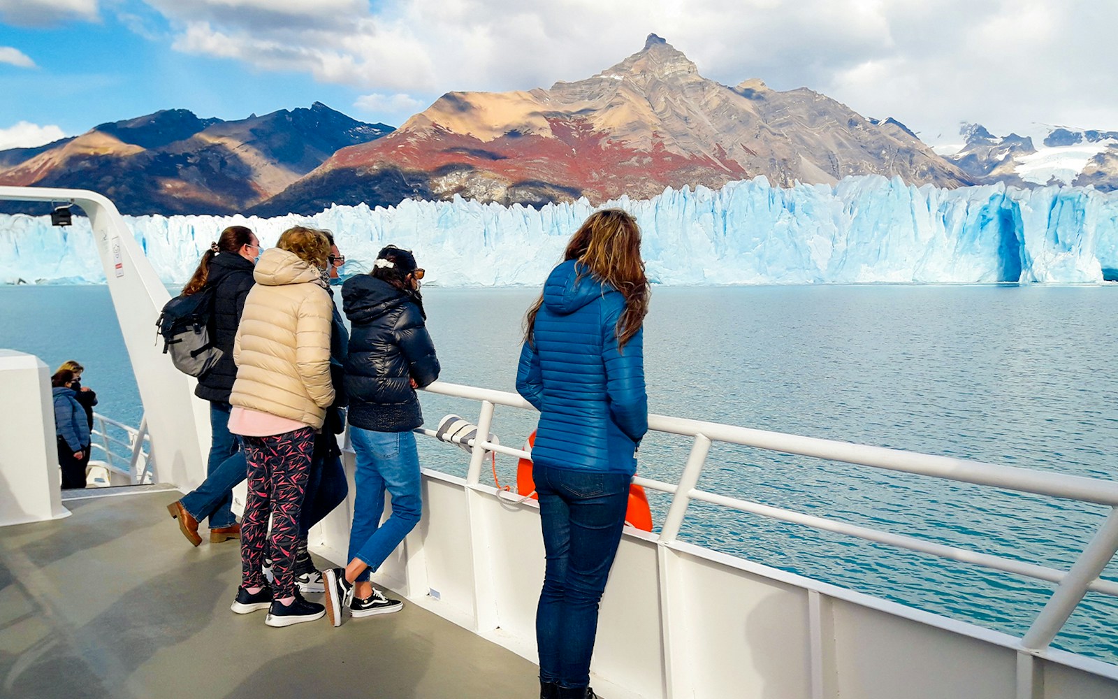 Tourists on cruise deck viewing Perito Moreno Glacier in Argentina.