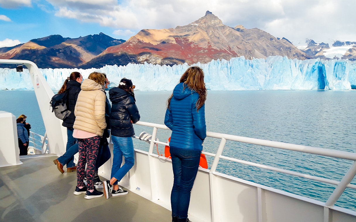 Tourists on cruise deck viewing Perito Moreno Glacier in Argentina.