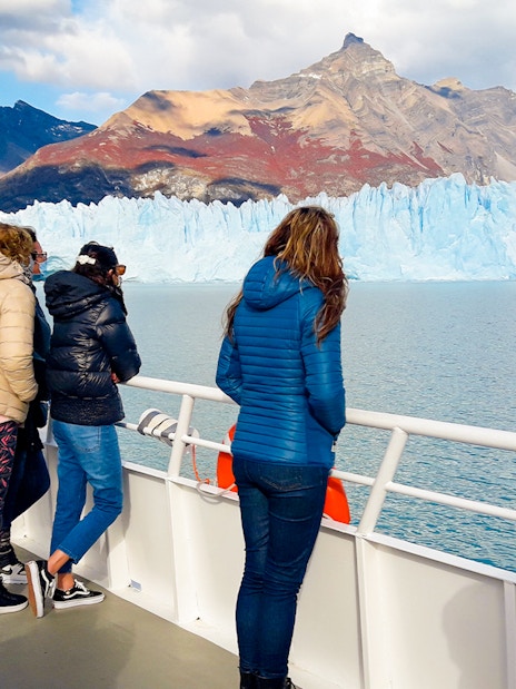 Tourists on cruise deck viewing Perito Moreno Glacier in Argentina.