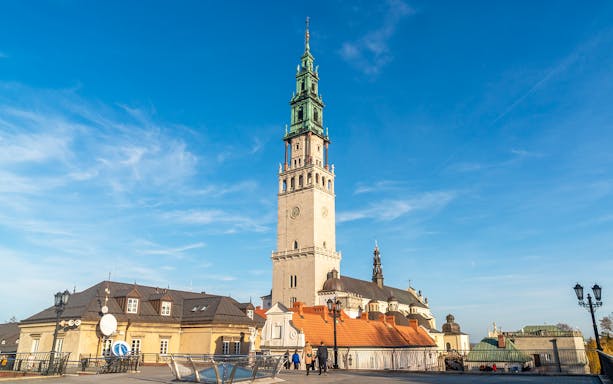Jasna Gora Monastery tower in Czestochowa, Poland, under a clear blue sky.