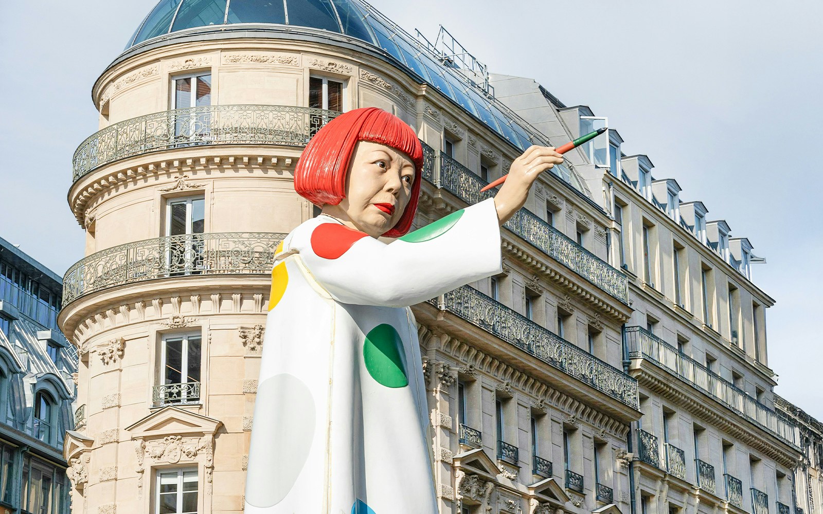 Yayoi Kusama sculpture with polka dots in Paris, France, near a modern art museum.