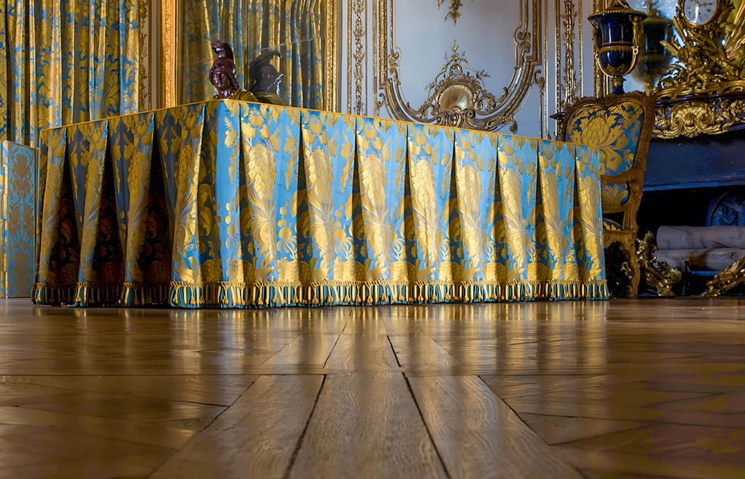 Kings Apartment Council Room in Versailles Palace with ornate decor and historical furnishings.
