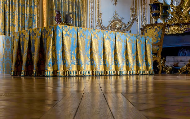 Luxurious draped table in the King's Apartment Council Room, Versailles Palace.