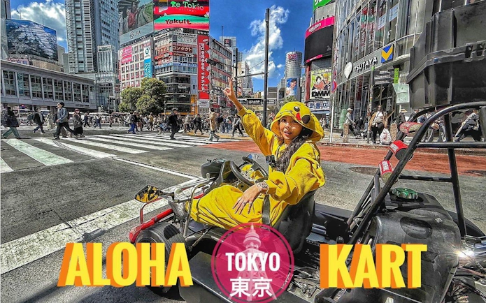 Tourist in costume driving a go-kart at Shibuya Crossing, Tokyo.