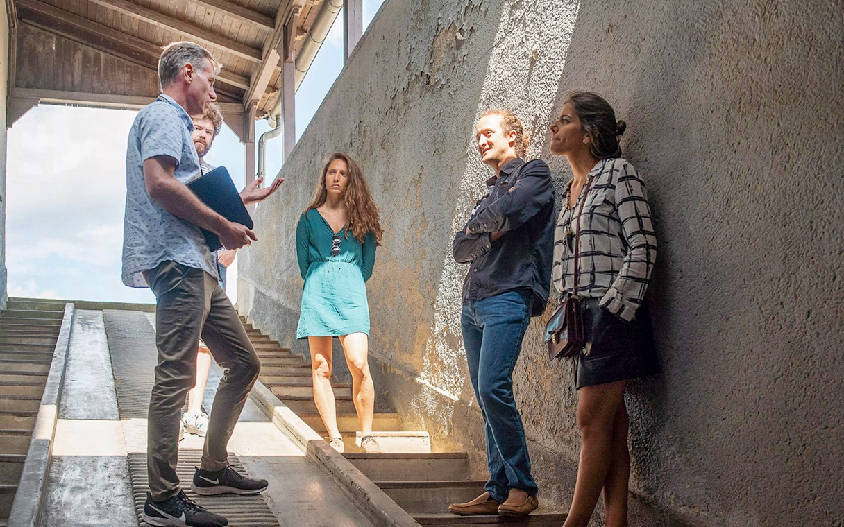 Guests listening to a tour guide at Sachsenhausen Concentration Camp Memorial.