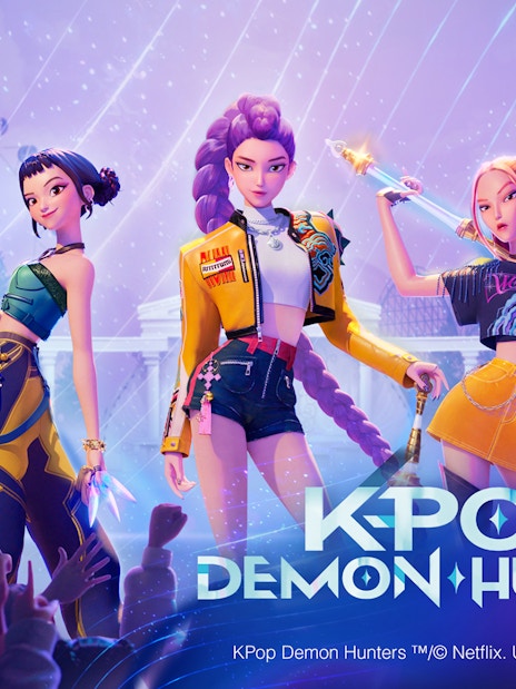 K-pop demon hunters at Everland Resort with roller coaster backdrop.
