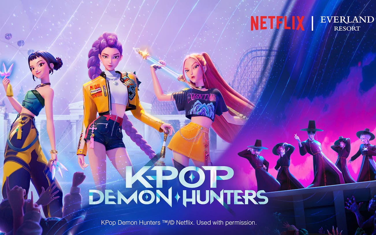 K-pop demon hunters at Everland Resort with roller coaster backdrop.